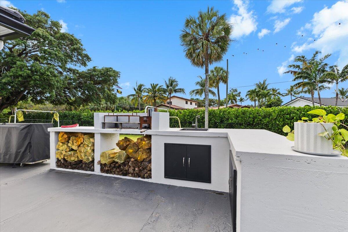 1049 West Palmetto Park Road Boca Raton, FL 33486 - Photo 29 of 40 a view of outdoor space with seating area and trees in the background