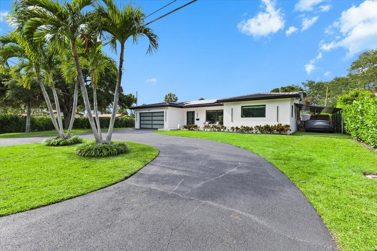 1049 West Palmetto Park Road Boca Raton, FL 33486 - Photo 3 of 40 a view of house with a yard