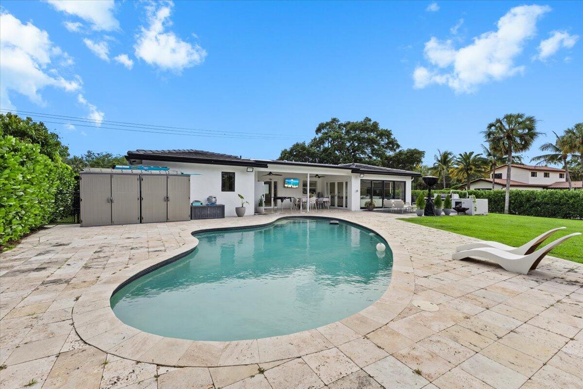 1049 West Palmetto Park Road Boca Raton, FL 33486 - Photo 31 of 40 a view of a house with swimming pool and sitting area