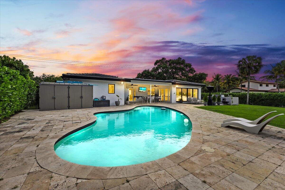 1049 West Palmetto Park Road Boca Raton, FL 33486 - Photo 32 of 40 a view of a swimming pool with a yard