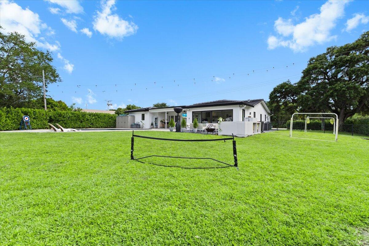 1049 West Palmetto Park Road Boca Raton, FL 33486 - Photo 35 of 40 a house view with a garden