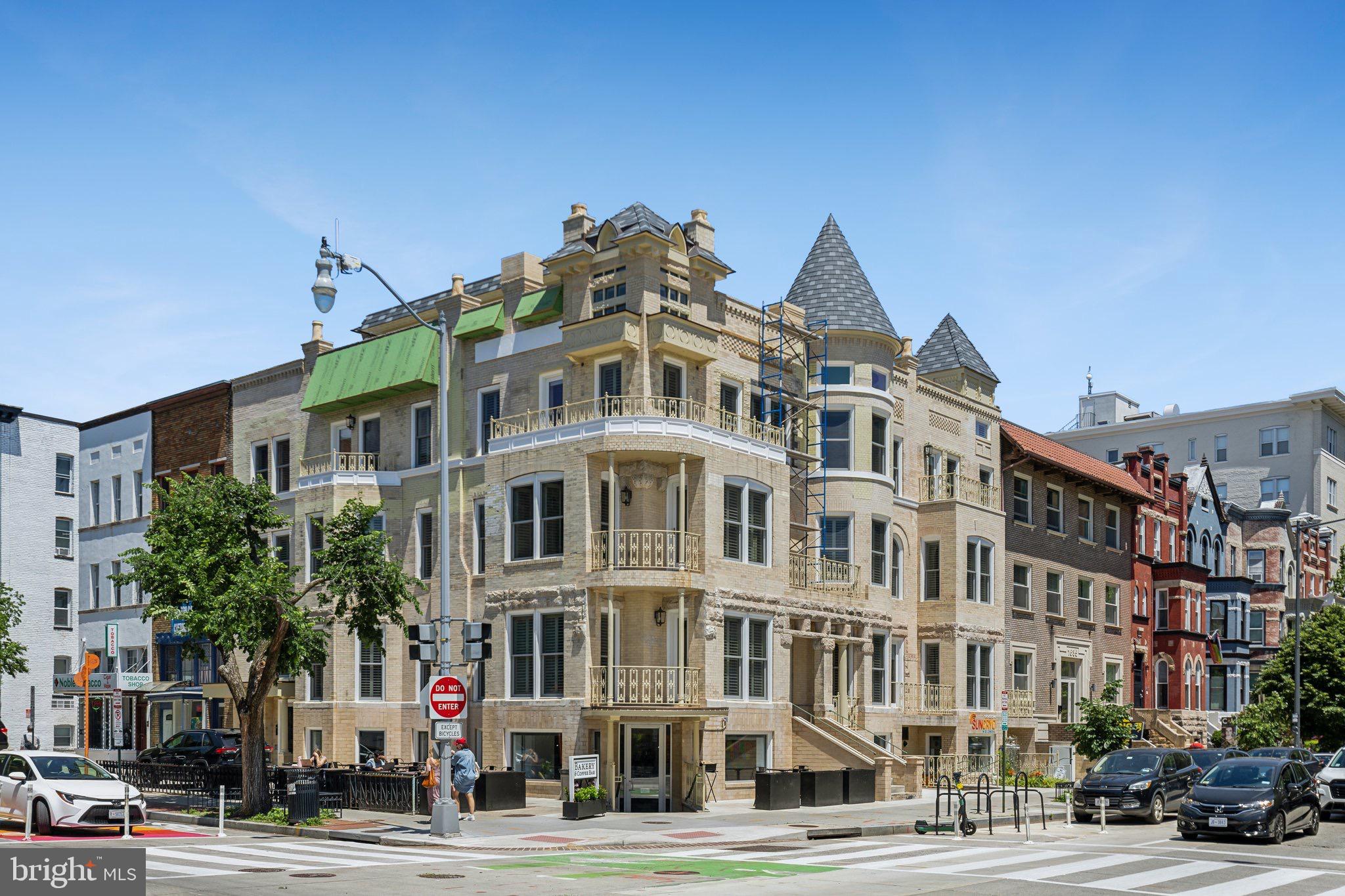 Charming historic building at a bustling corner.