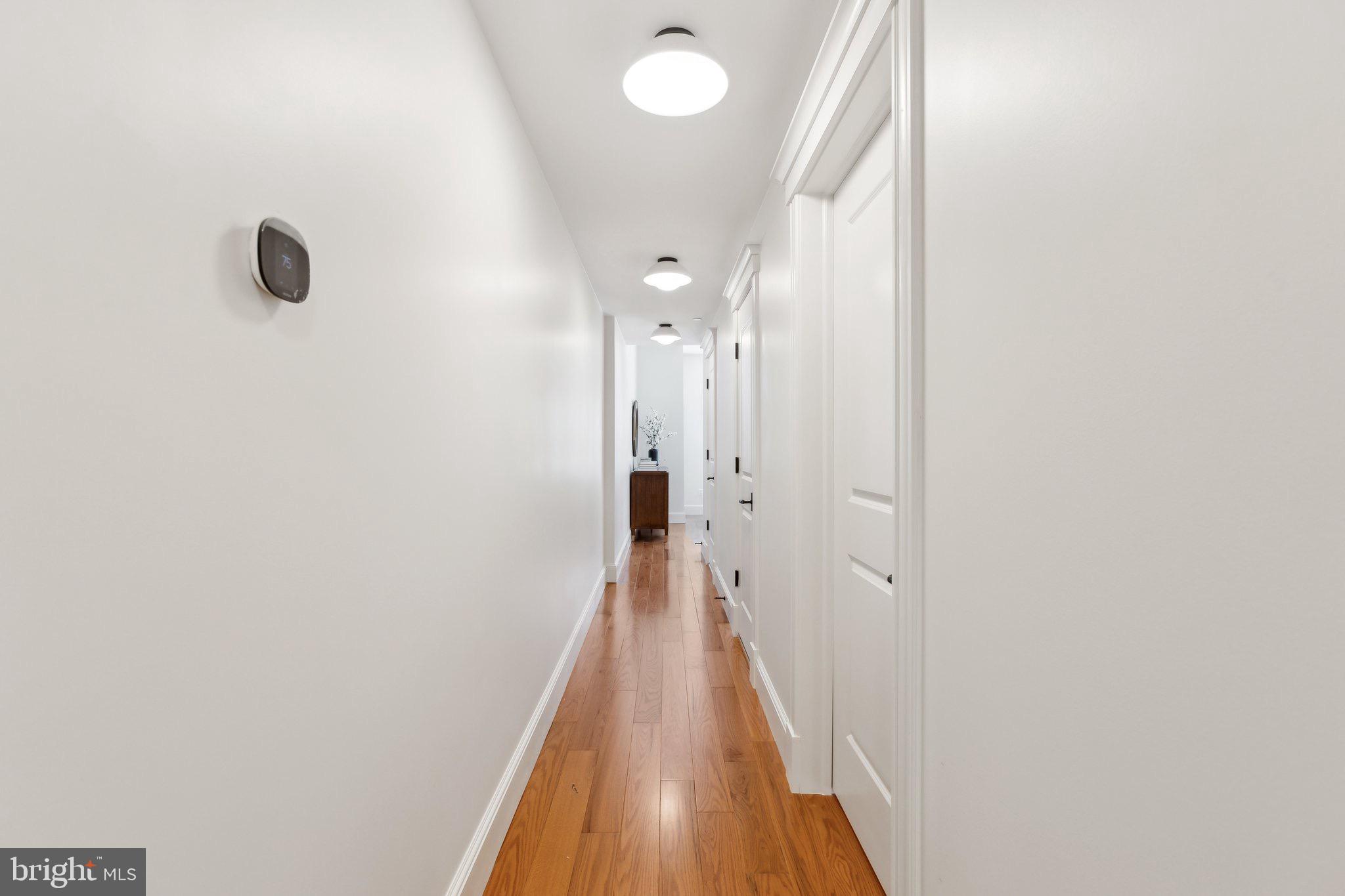 1641 R Street Northwest, Unit 201 Washington, DC 20009 - Photo 14 of 36 Bright and inviting hallway with warm tones.