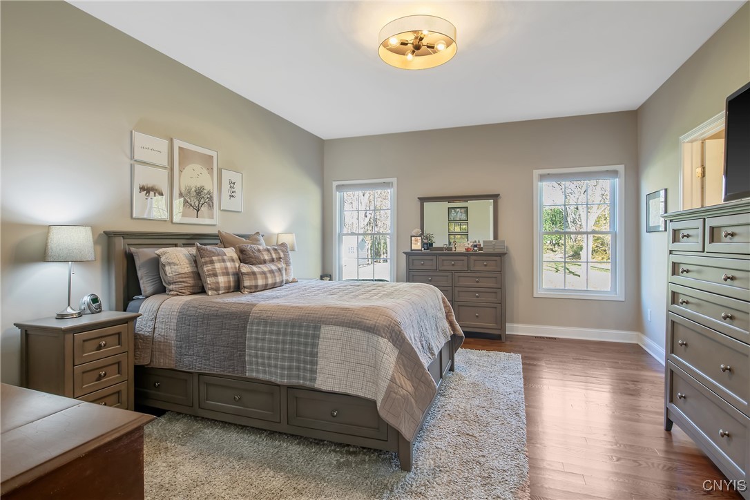 4304 Tiger Lily Path Clay, NY 13090 - Photo 16 of 50 Large primary bedroom with hardwood flooring