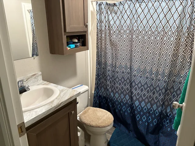 a bedroom with furniture and a flat screen tv
