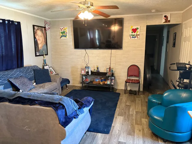 a living room with furniture and a flat screen tv