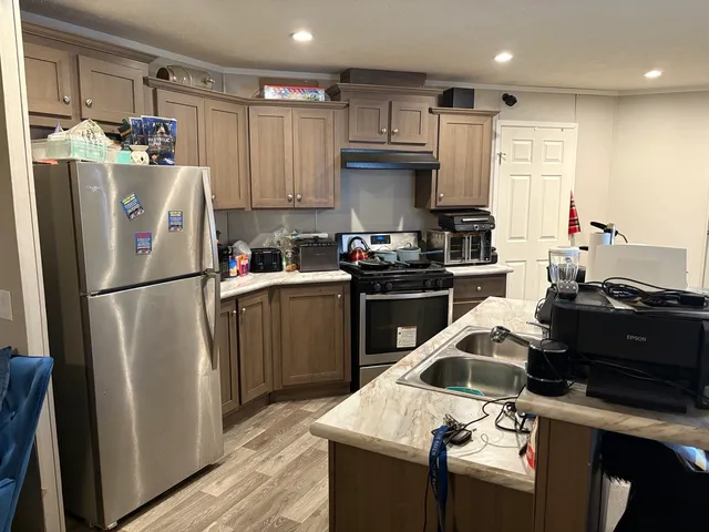a kitchen with a sink a stove and refrigerator