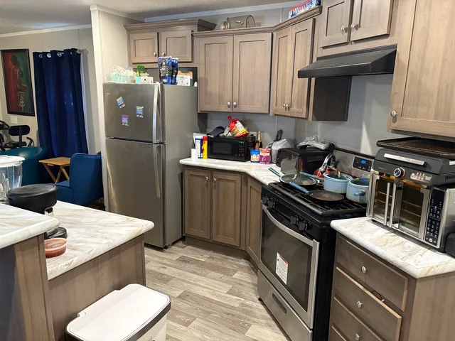 a kitchen with a sink stove and refrigerator