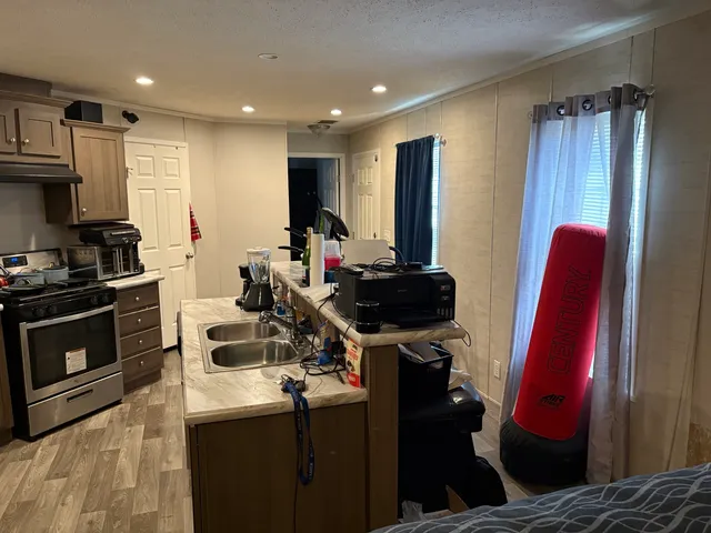 a view of a kitchen with fridge and workspace