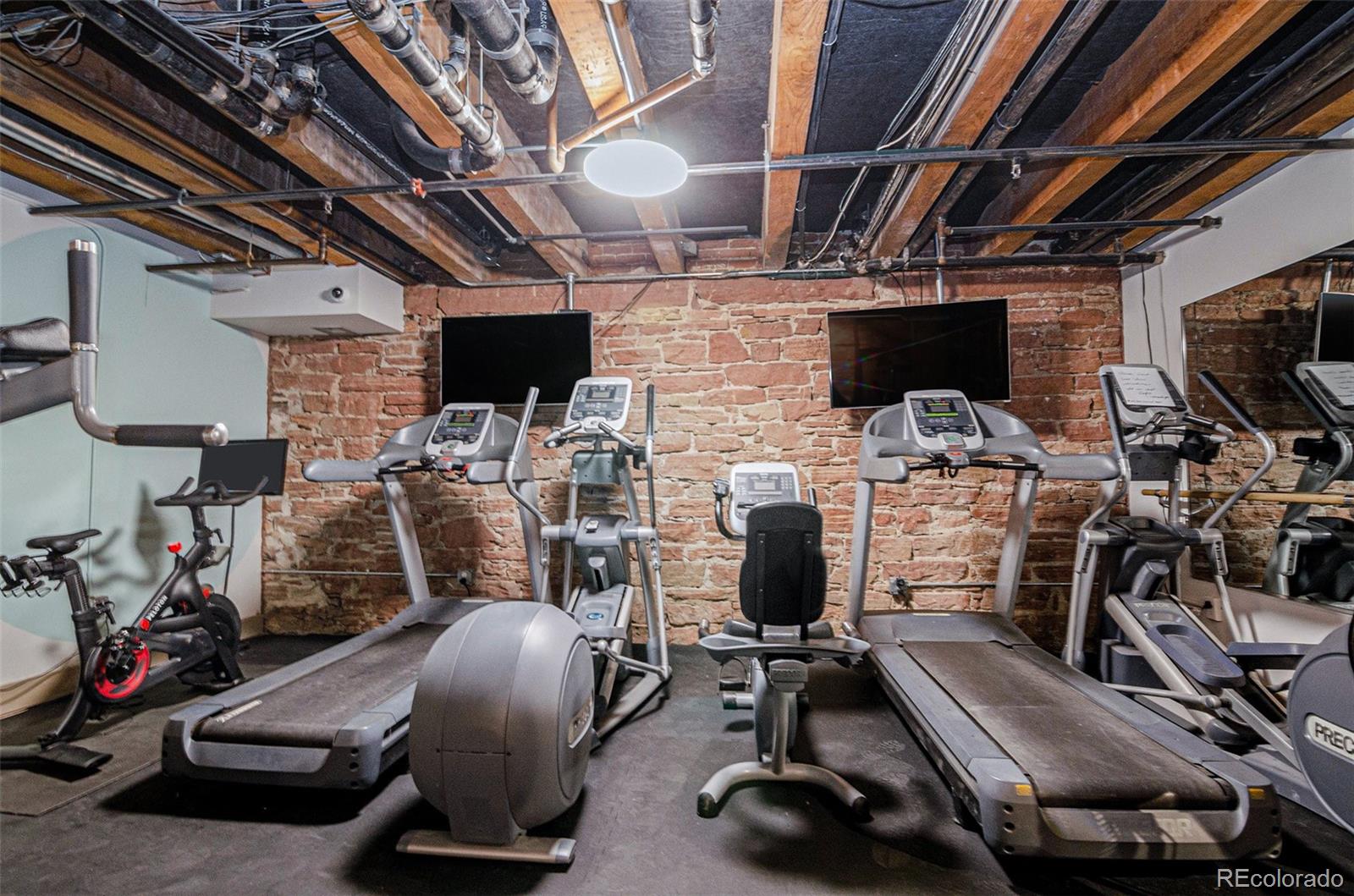 2960 Inca Street, Unit 417 Denver, CO 80202 - Photo 11 of 14 a room with gym equipment and a flat screen tv
