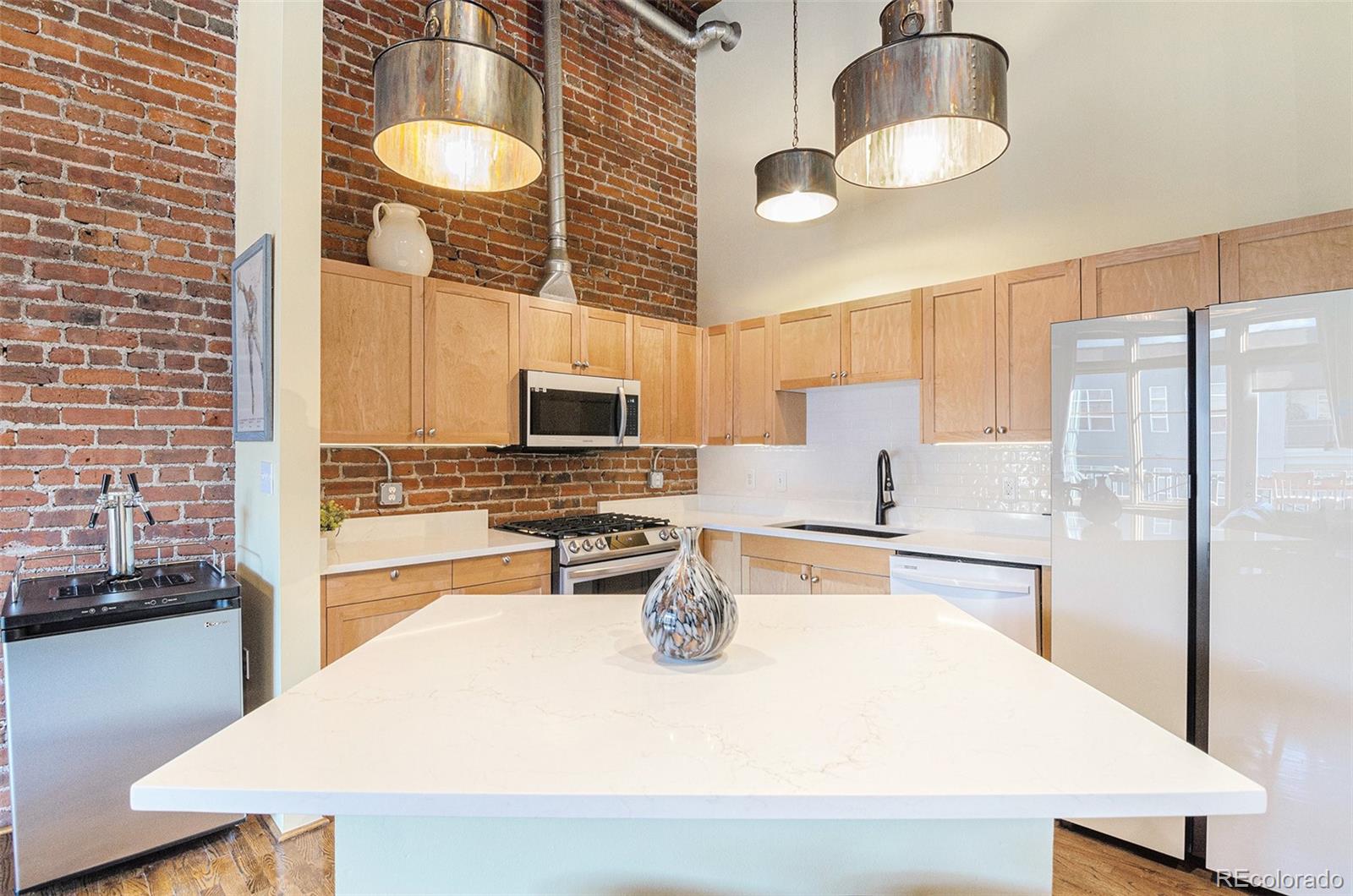 2960 Inca Street, Unit 417 Denver, CO 80202 - Photo 5 of 14 a kitchen with stainless steel appliances granite countertop a sink a stove and refrigerator