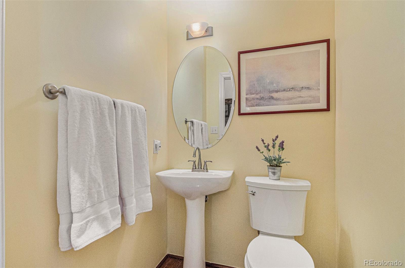 2960 Inca Street, Unit 417 Denver, CO 80202 - Photo 6 of 14 a bathroom with a toilet sink and mirror