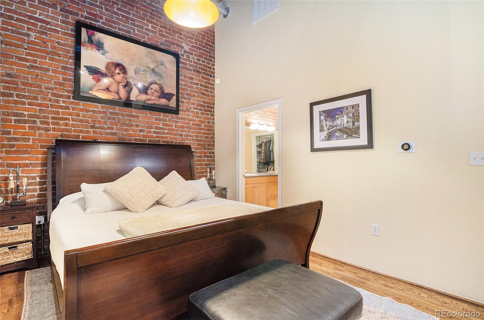 2960 Inca Street, Unit 417 Denver, CO 80202 - Photo 7 of 14 a bedroom with a bed and wall paintings