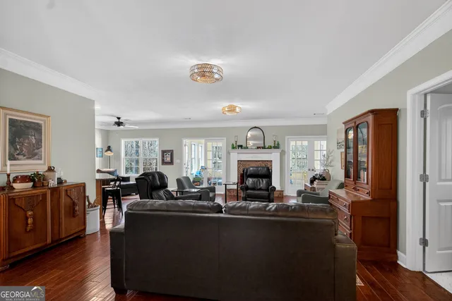 a living room with fireplace furniture and a large window