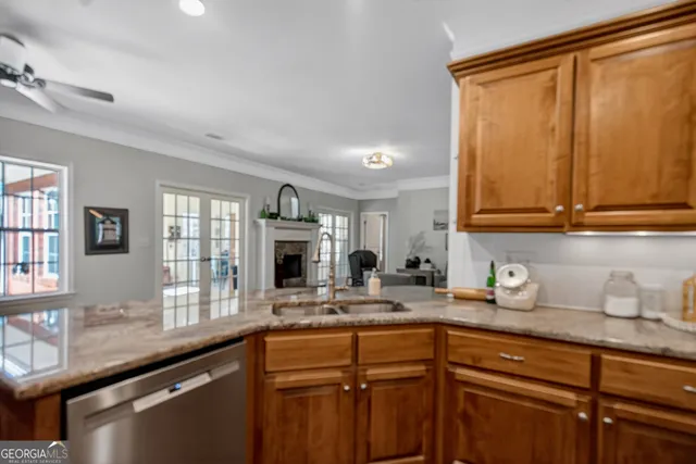 a kitchen with granite countertop a sink stainless steel appliances and cabinets