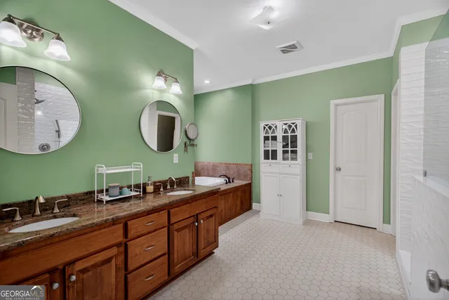 a spacious bathroom with a double vanity sink and a mirror