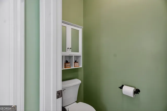a white toilet sitting next to a bathroom sink