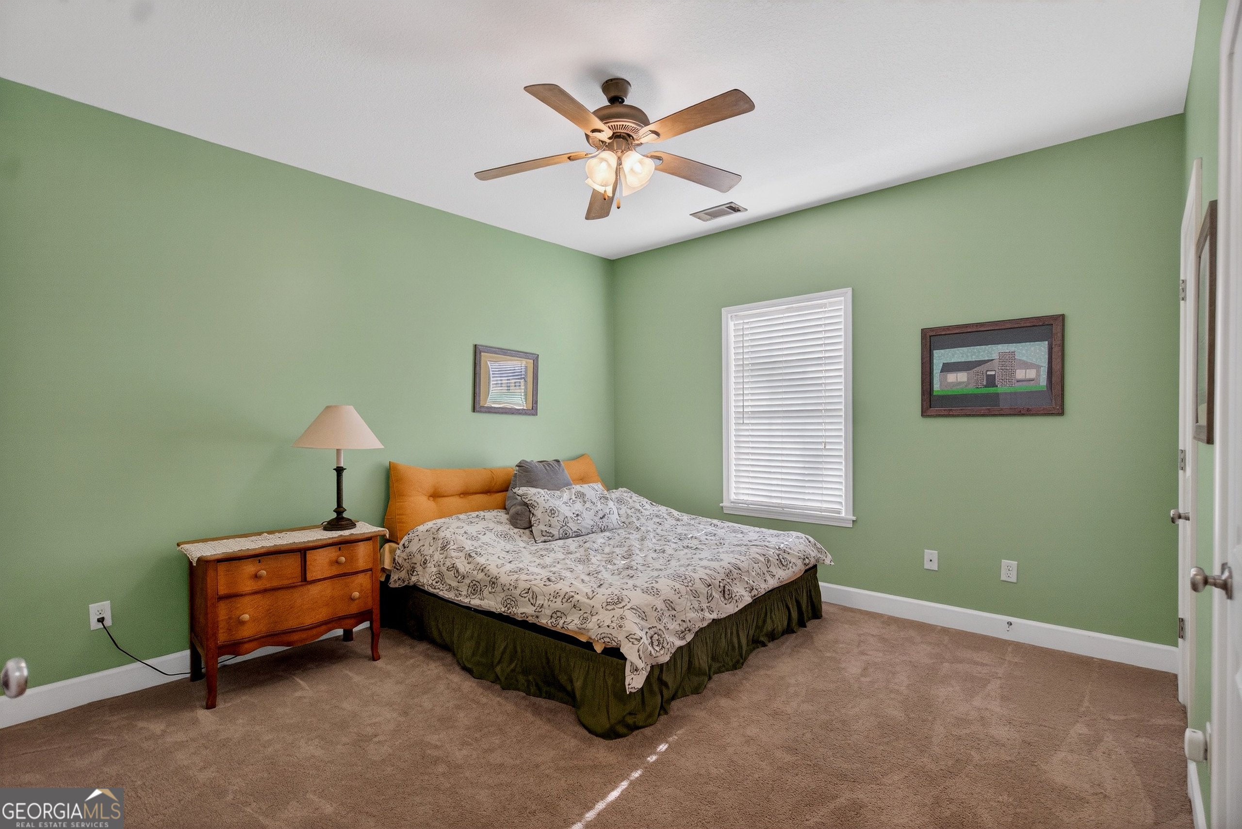 830 John Lovelace Road LaGrange, GA 30241 - Photo 24 of 45 a bedroom with a bed and a chandelier
