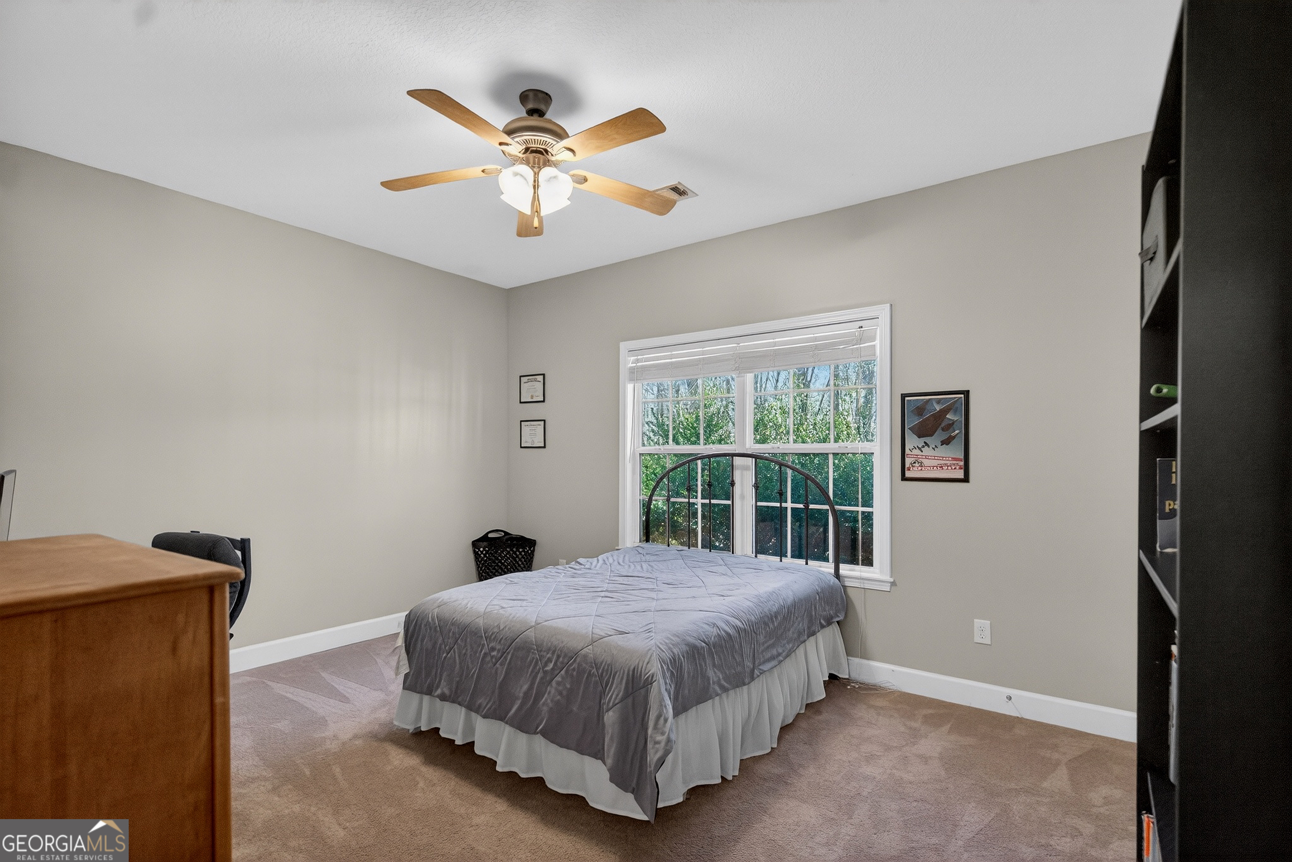 830 John Lovelace Road LaGrange, GA 30241 - Photo 27 of 45 a bedroom with a large bed and a chandelier