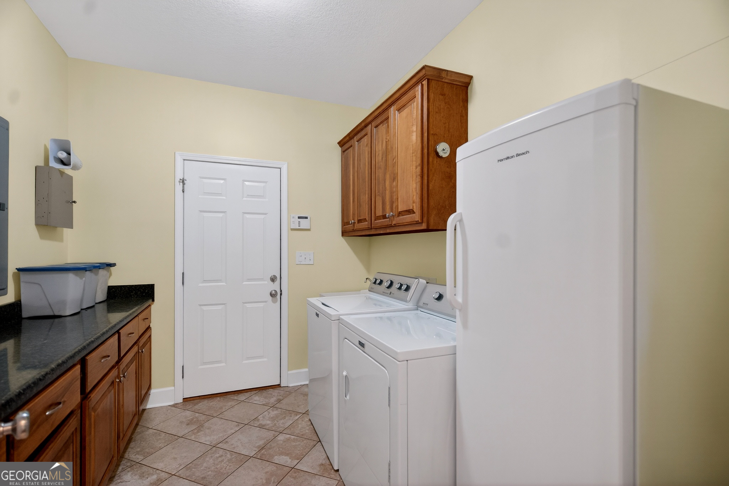 830 John Lovelace Road LaGrange, GA 30241 - Photo 28 of 45 a utility room with cabinets washer and dryer