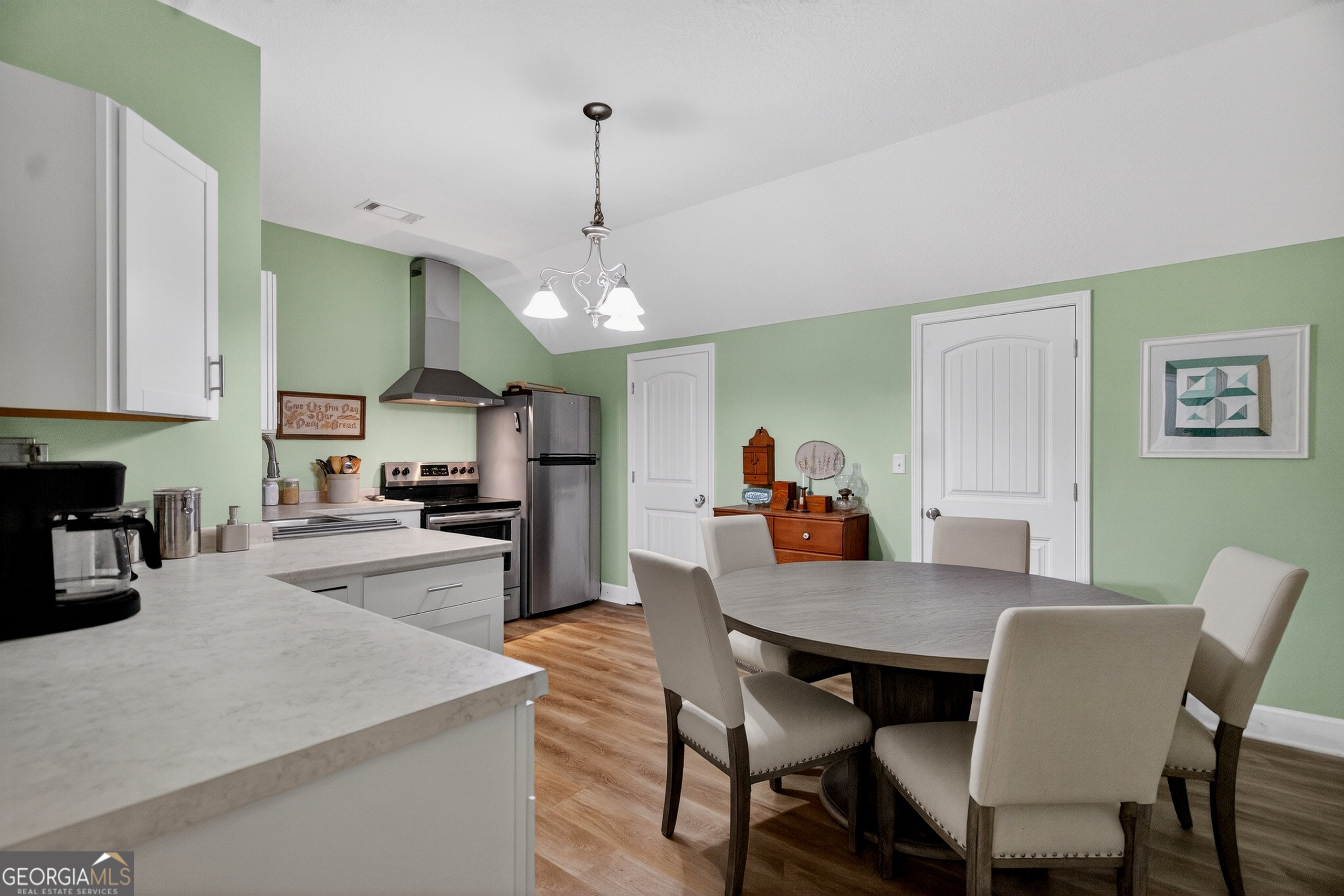 830 John Lovelace Road LaGrange, GA 30241 - Photo 34 of 45 a view of a dining room and livingroom with furniture wooden floor a rug a painting and a chandelier