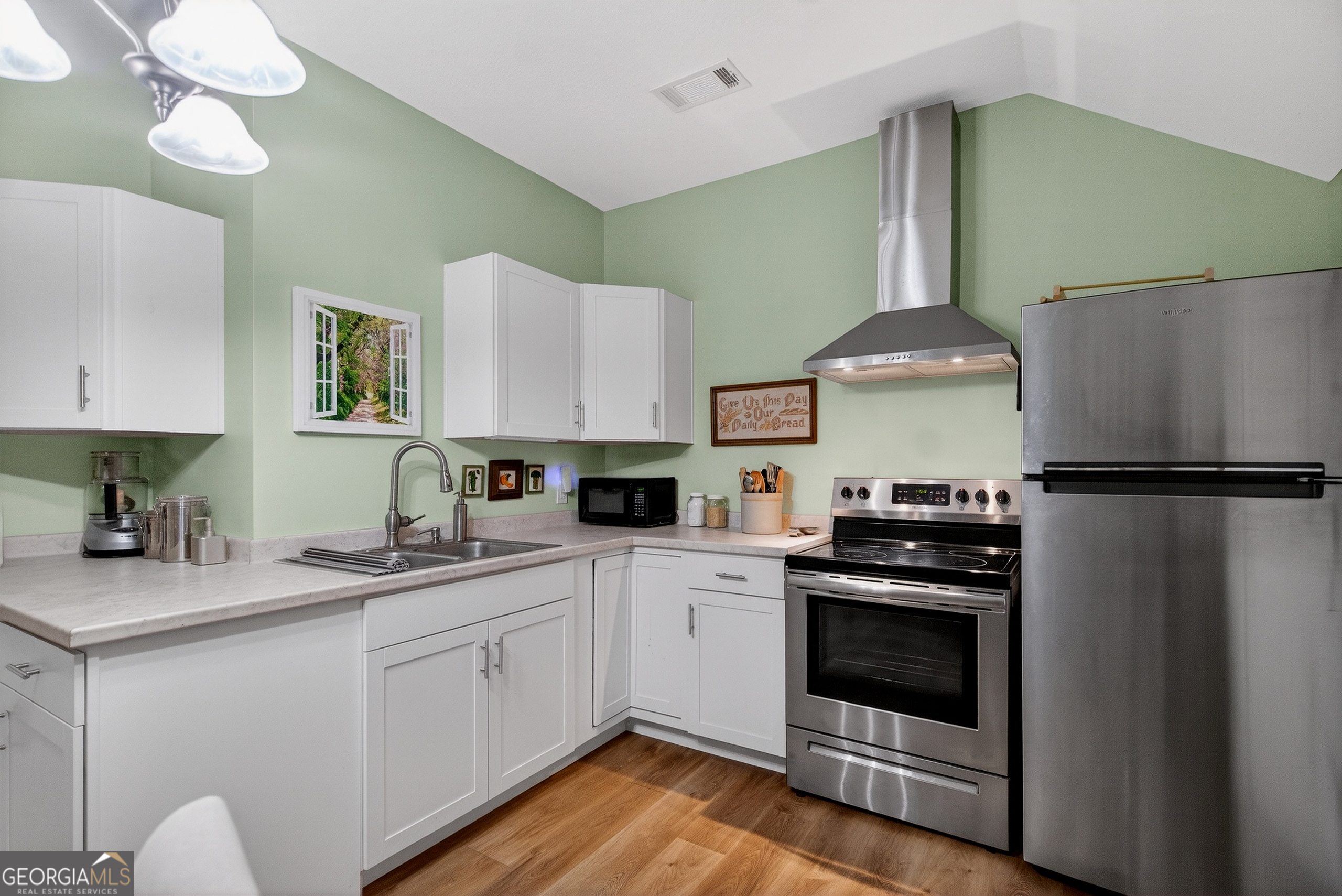 830 John Lovelace Road LaGrange, GA 30241 - Photo 36 of 45 a kitchen with a stove a sink and a refrigerator