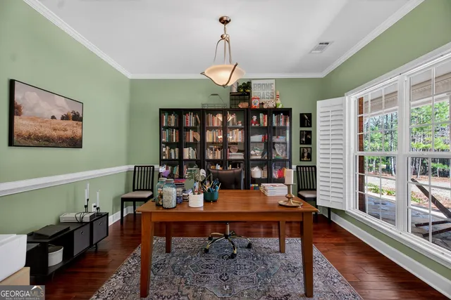 a reading room with furniture book shelf and wooden floor