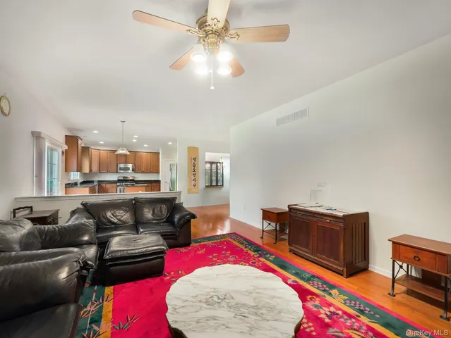 a living room with furniture and a book shelf