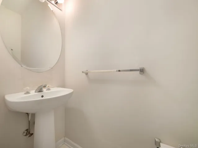a bathroom with a sink a mirror and a toilet