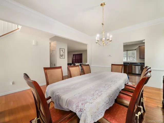 a view of a dining room with furniture and chandelier