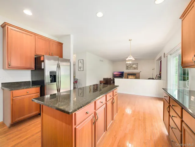 a kitchen with stainless steel appliances granite countertop a sink a stove and a refrigerator