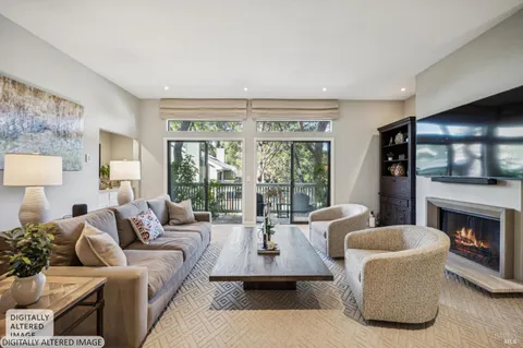 a living room with furniture a fireplace and a large window