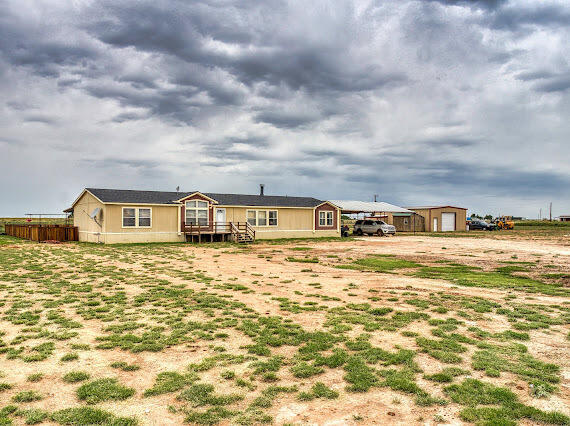 6341 Farm Private Road Levelland, TX 79336 - Photo 4 of 46 a front view of a house with a yard