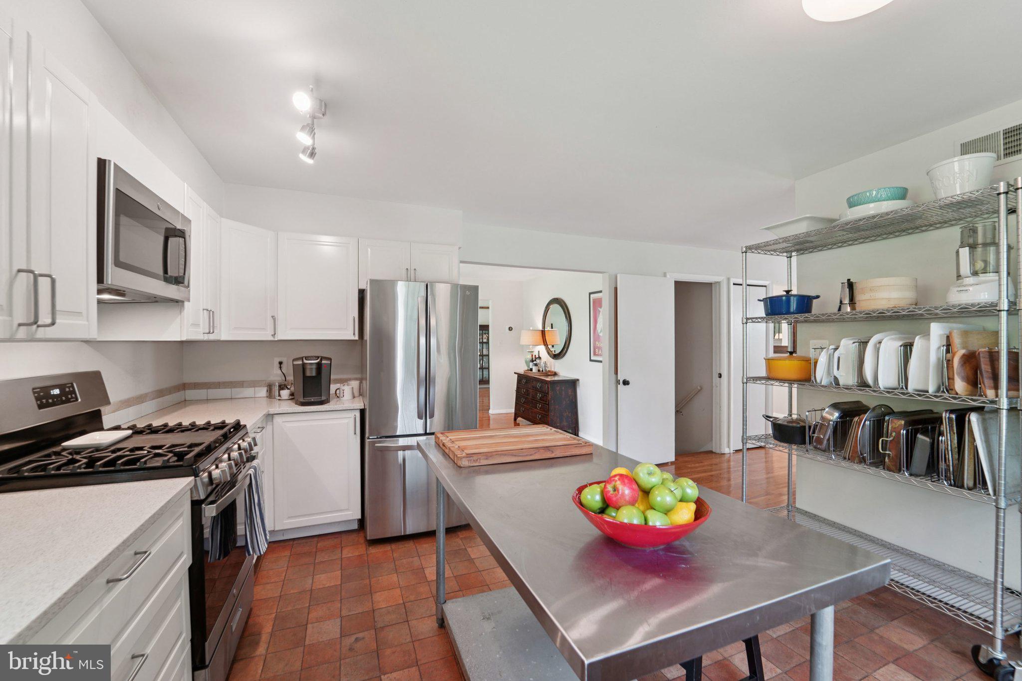 15108 Watergate Road Silver Spring, MD 20905 - Photo 12 of 33 a kitchen view with table chairs refrigerator and stove