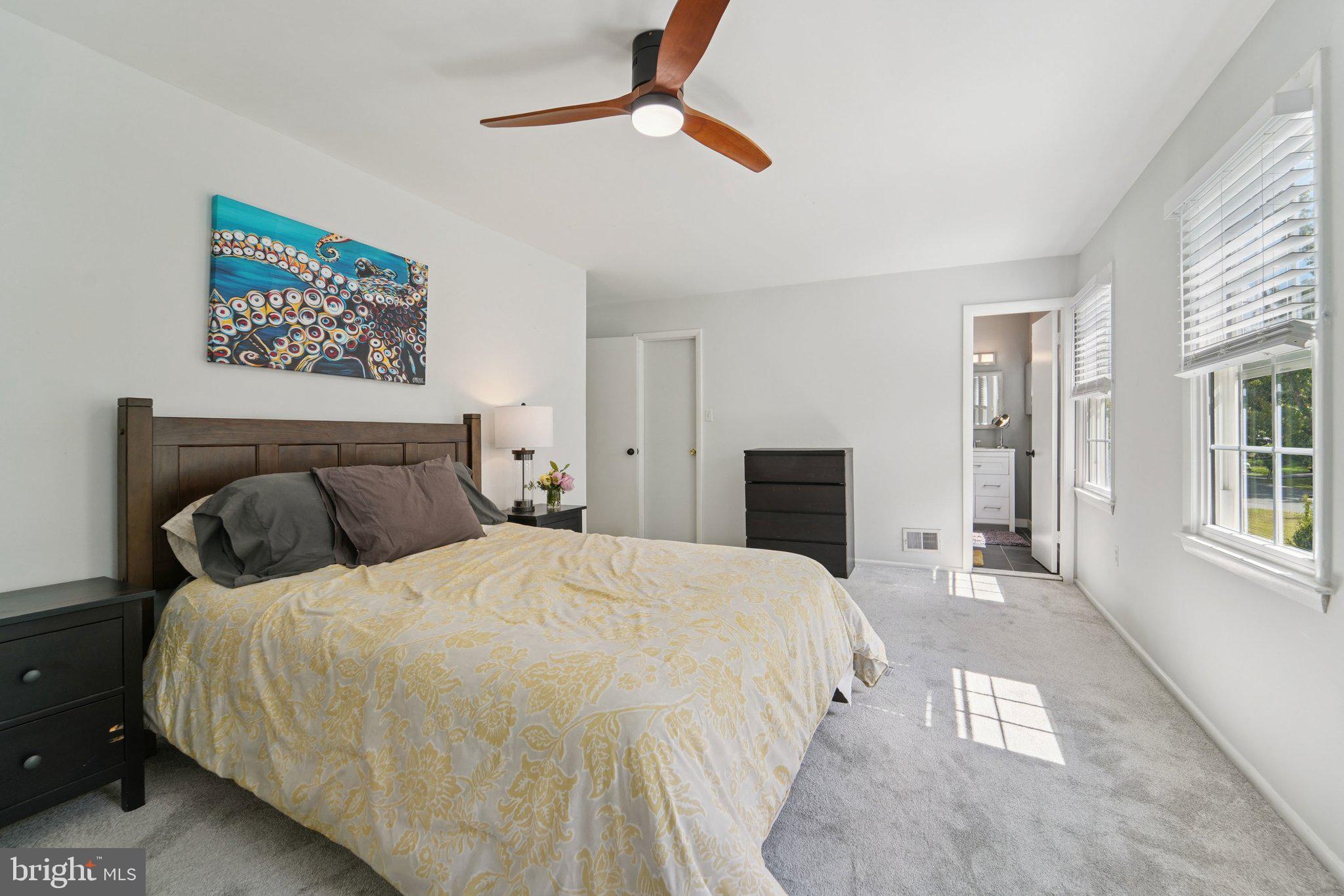 15108 Watergate Road Silver Spring, MD 20905 - Photo 16 of 33 a bedroom with a large bed and a chandelier fan