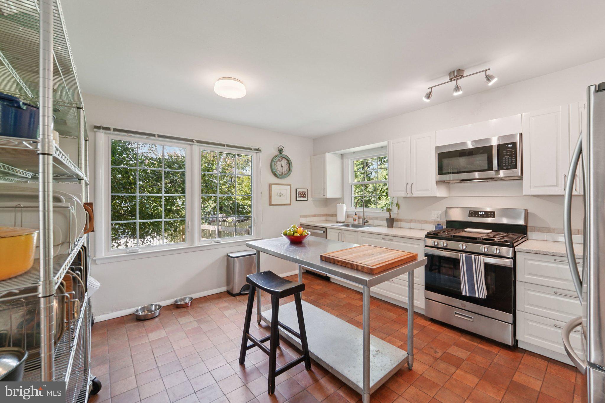 15108 Watergate Road Silver Spring, MD 20905 - Photo 9 of 33 a kitchen with a stove a sink and a refrigerator