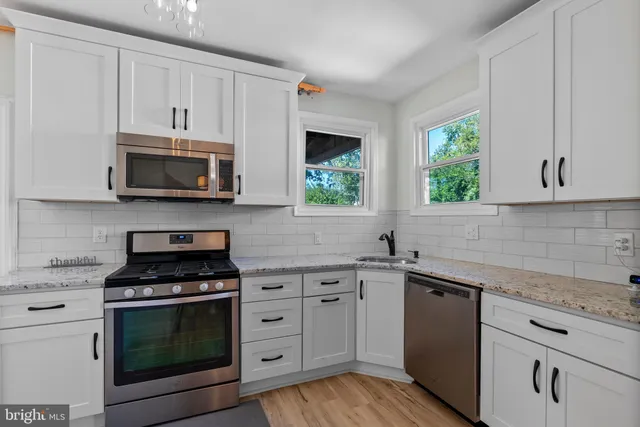 a kitchen with stainless steel appliances a refrigerator and a sink