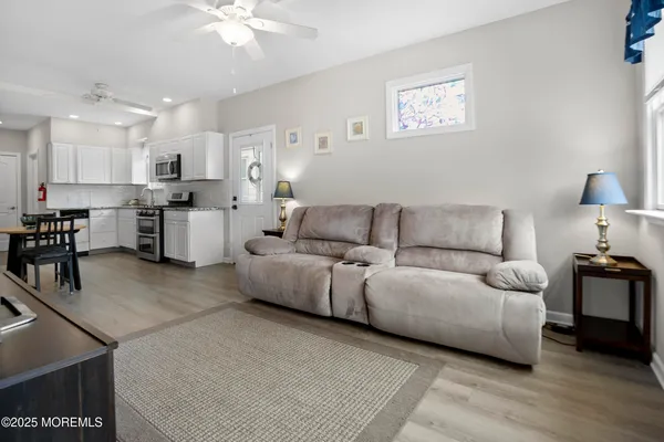 a living room with furniture and kitchen view