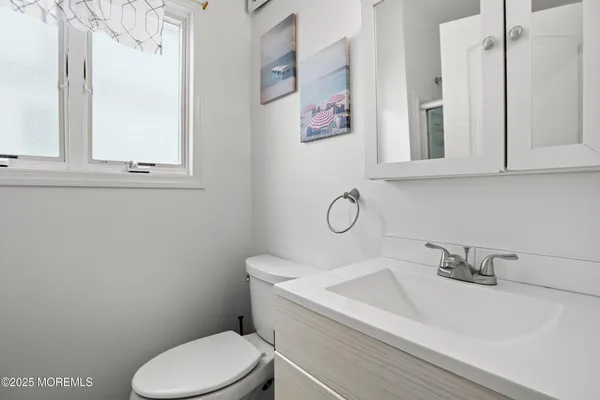 a white toilet sitting next to a bathroom sink