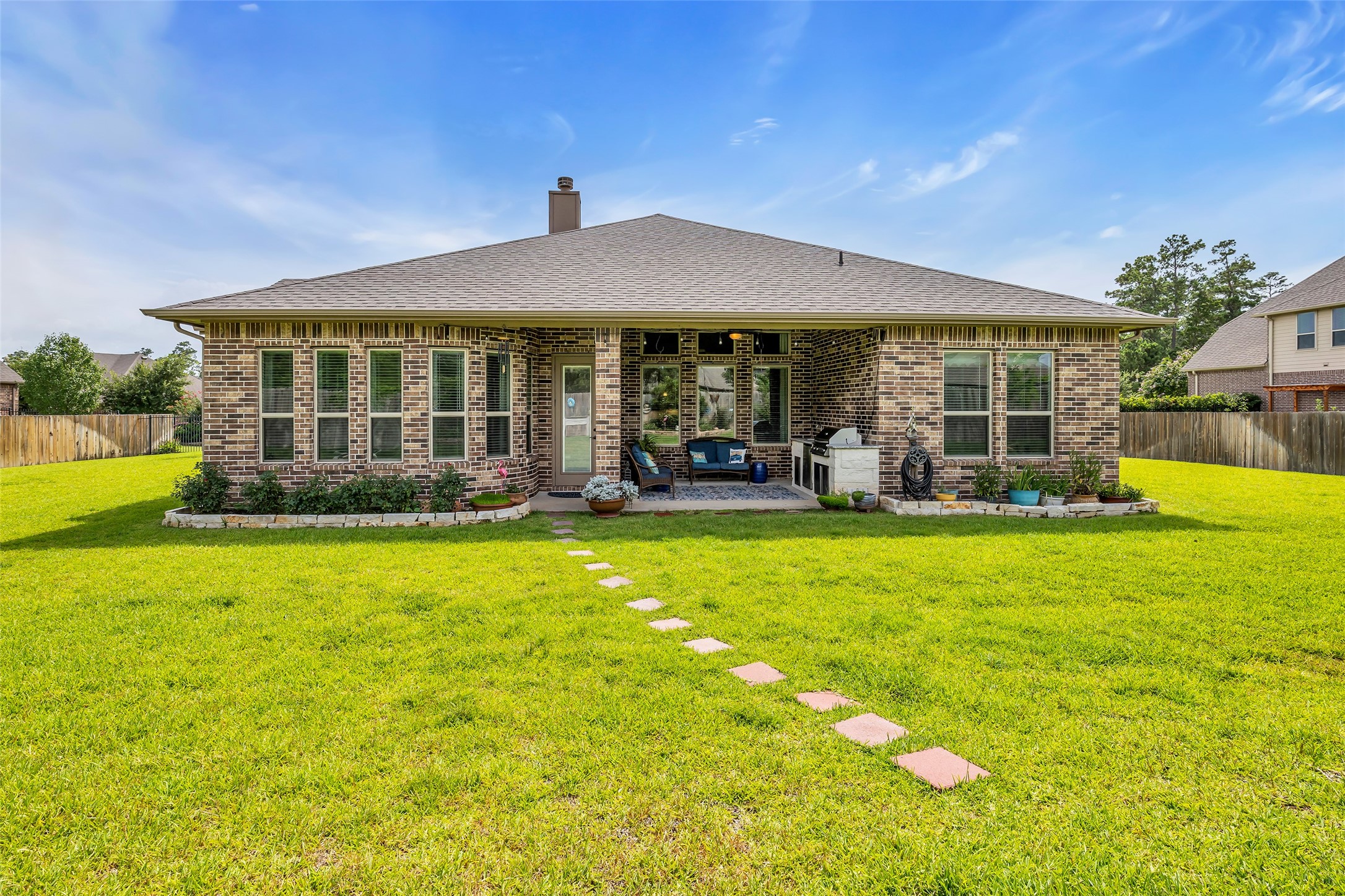 14003 South Evergreen Ridge Court Conroe, TX 77384 - Photo 33 of 43 Covered patio, outdoor kitchen, and nearly half-acre backyard create an exceptional outdoor living experience.