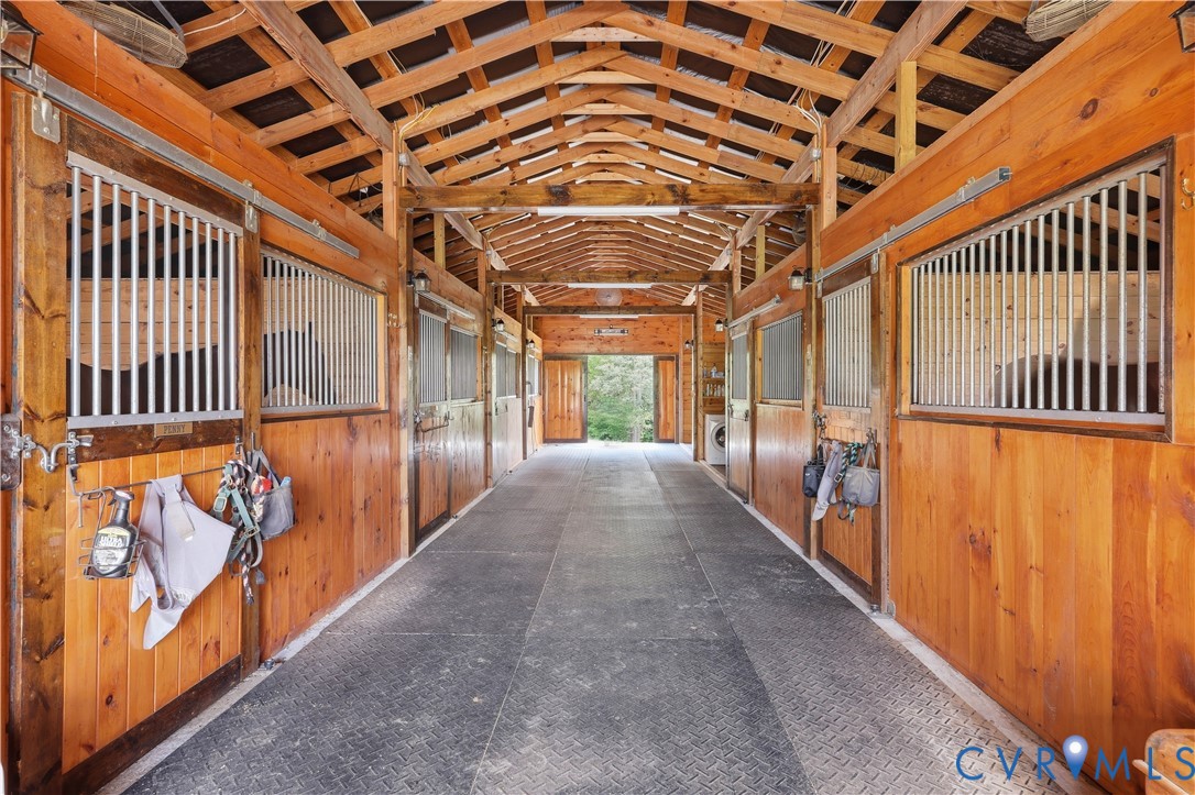 25181 West Soap Stone Road Jetersville, VA 23083 - Photo 42 of 54 Barn interior featuring multiple stalls with wood