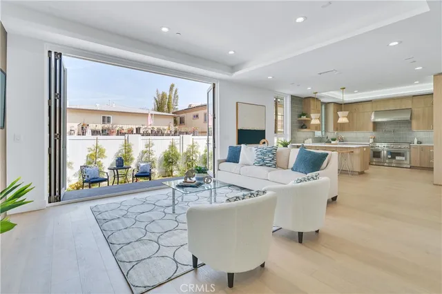 a living room with furniture a flat screen tv and a large window
