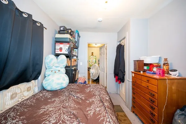 a bedroom with a bed and a closet