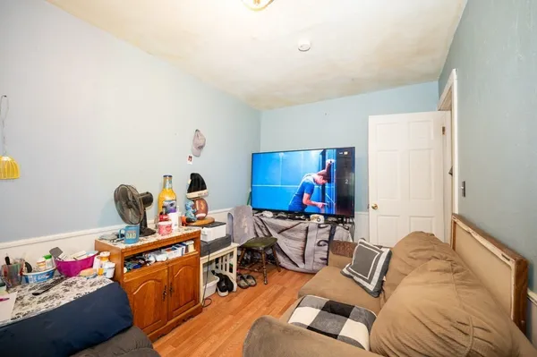 a living room with furniture a air conditioner vent and a window