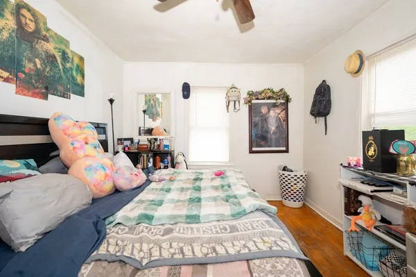 a bedroom with furniture and a wooden floor