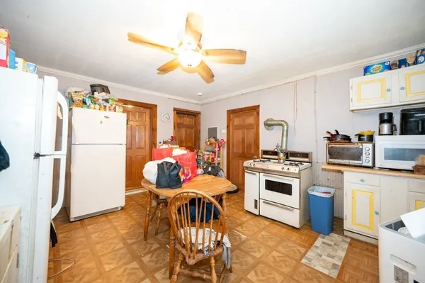 a kitchen with stainless steel appliances granite countertop a stove refrigerator and a dining table with wooden floor