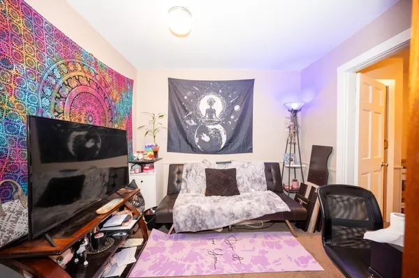a bedroom with furniture and a flat screen tv