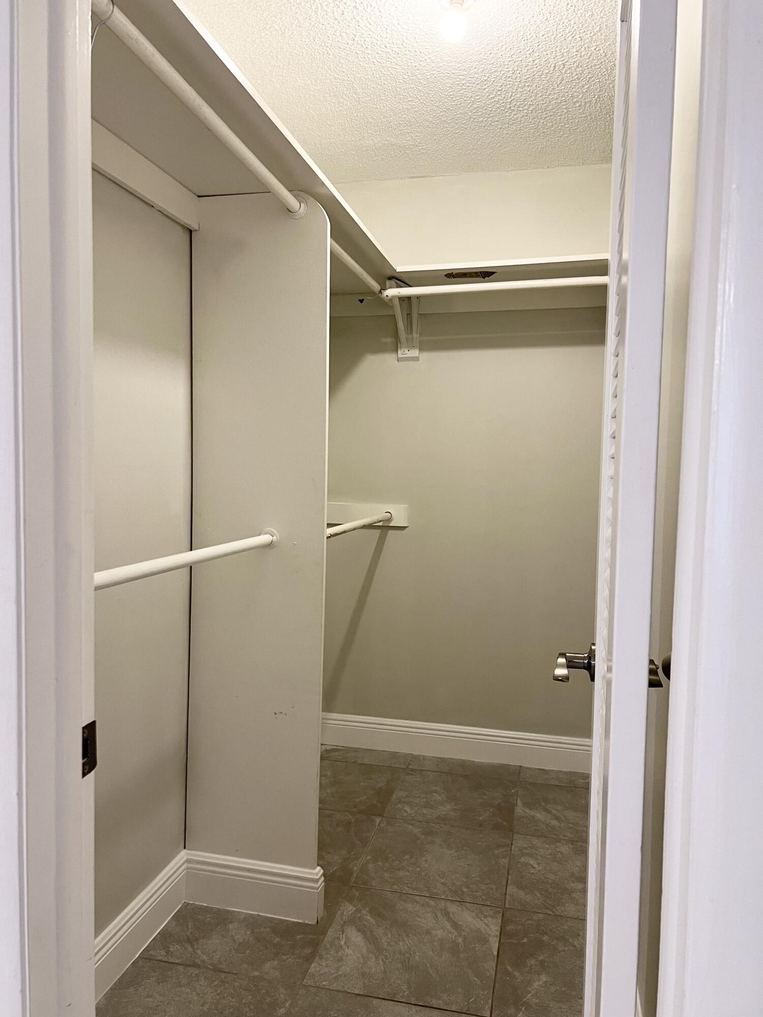 150 Burgandy Way, Unit D Delray Beach, FL 33484 - Photo 16 of 33 a bathroom with a glass door shower