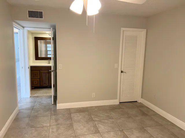 an empty room that has a mirror in it