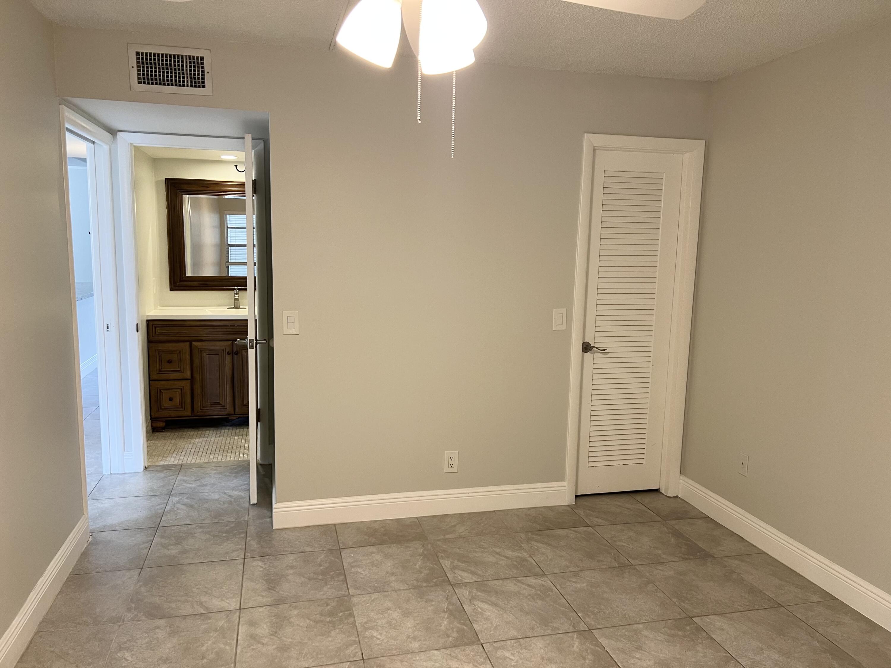 150 Burgandy Way, Unit D Delray Beach, FL 33484 - Photo 17 of 33 an empty room that has a mirror in it